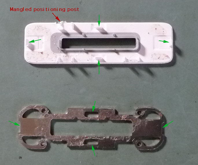 The 4 tabs of the plastic piece latch onto mating edges of the metal retaining bracket.
