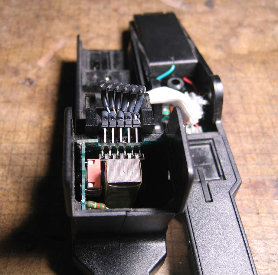 both plugs unplogged, hovering over their sockets and the visible (top) one over the hidden one