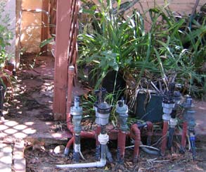 conduit from backyard valves to house runs along trellis